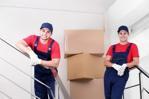 Professional movers handling belongings with care and PPE
