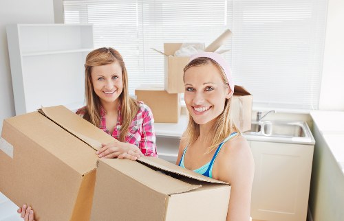 Professional movers preparing furniture for transport in Wandsworth