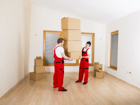 Removal team handling furniture in a Wandsworth property
